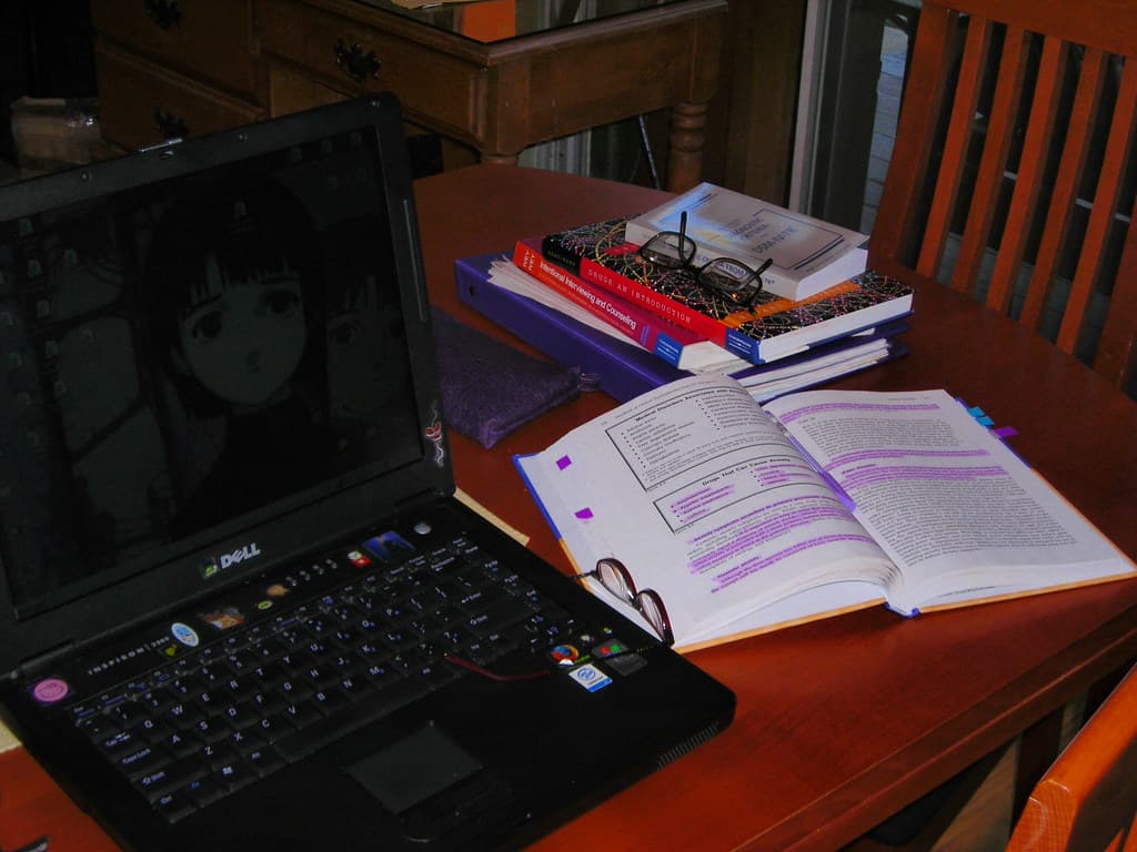 Desk setup with notes and laptop for a note-taking workflow